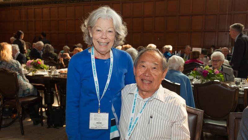 two alumni pose for a photo during the Chancellor's breakfast