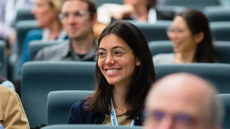 a female student listens to a lecture in a lecture hall