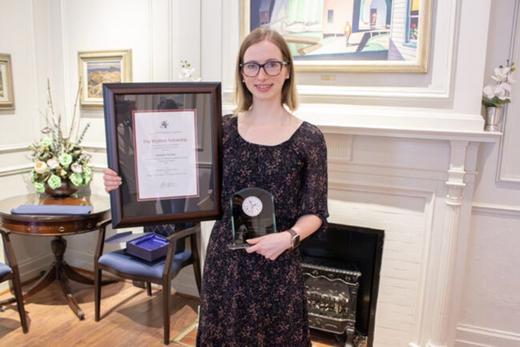 Jennifer Farmer holds up her award proudly