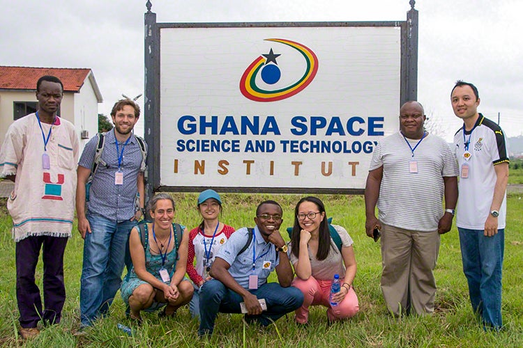 Linda Strubbe in front of a sign that says Ghana Space Science and Technology Institute