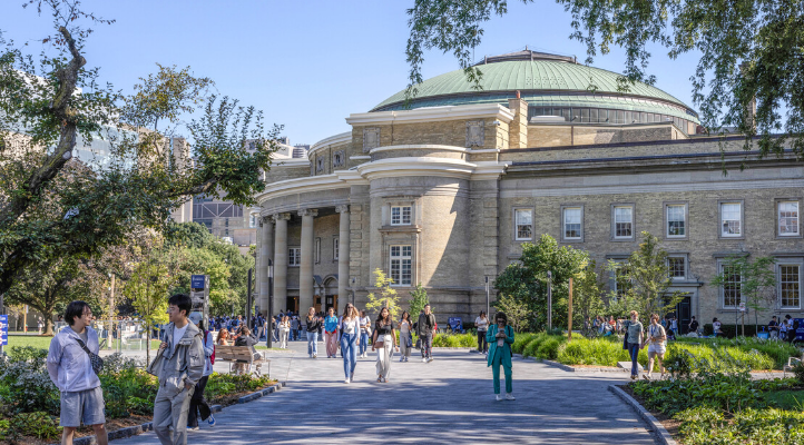 The exterior of Convocation Hall with people walking on a path in front