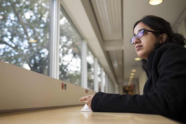 Apala Das in the Victoria College library