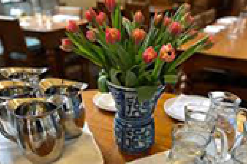 A table with a vase full of flowers.
