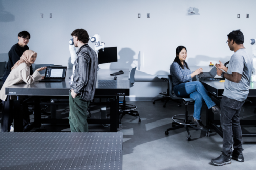 A group of students talking in a lab setting
