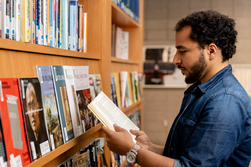 A student holds an open book