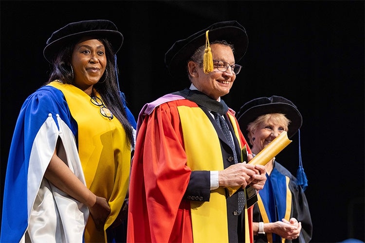 David Dyzenhaus stands on stage at the University of the Witwatersrand to recieve his honorary degree