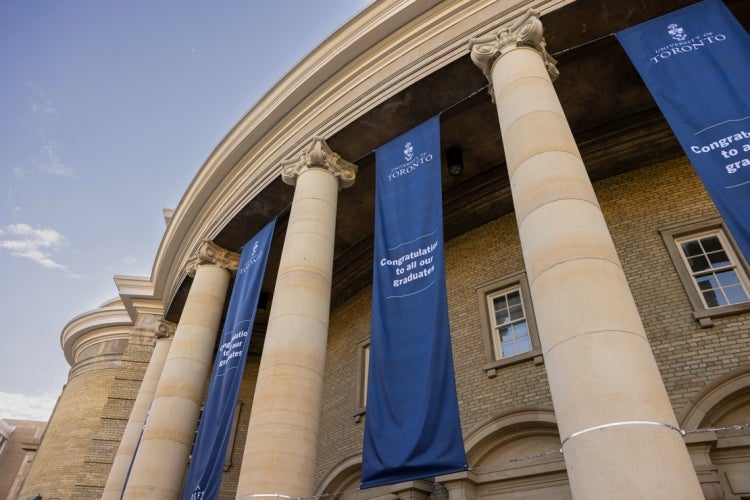 exterior view of convocation hall showing graduation banners