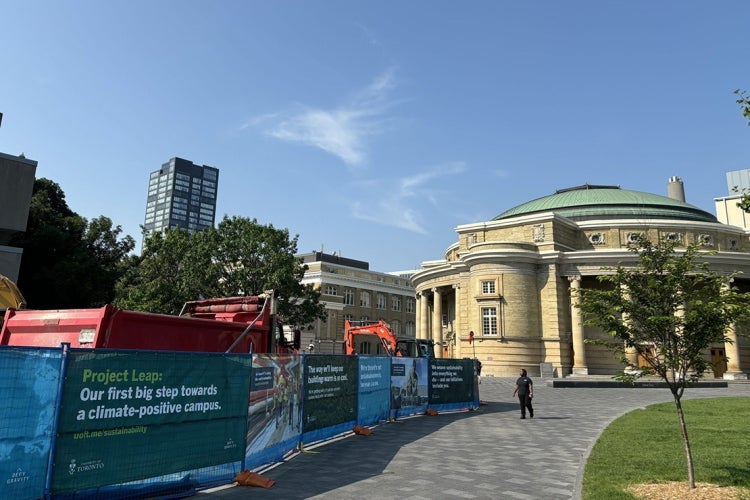 hoarding around the medical sciences building with convocation hall in the background
