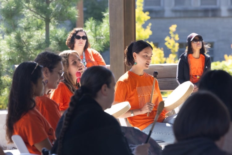 participants in a drumming circle at the Ziibiing Indigenous Garden outside of Hart House on the National Day for Truth and Reconciliation