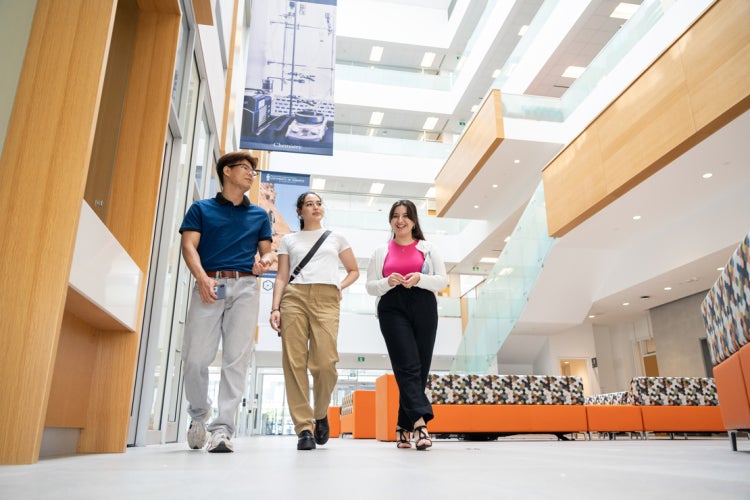 three students walk the halls at the. environmental sciences building at U of T Scarborough campus