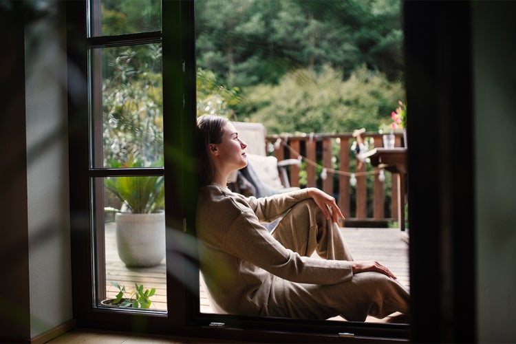 woman sitting and relaxing on her back deck