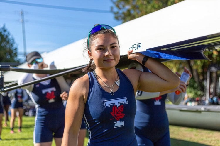 Vanessa Lin seen carrying a boat with her teammates