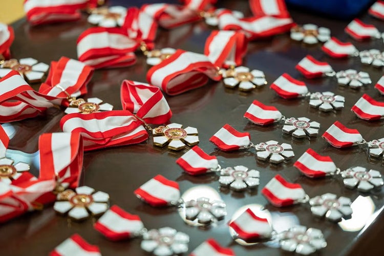 A table full of various Order of Canada medals