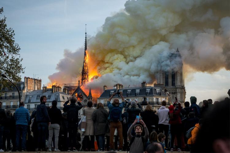 photo of the Notre Dame Cathedral in Paris as the roof burns