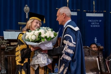 President Meric Gertler presents Chancellor Rose Patten with a bouquet at the conclusion of her 133rd convocation ceremony.  