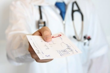 doctor handing over a signed prescription