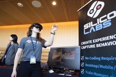 a woman demonstrates a VR experience for Silicon Labs at the University of Toronto