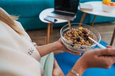 woman eating a bowl of granola