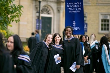 graduates seen smiling outside of simcoe hall