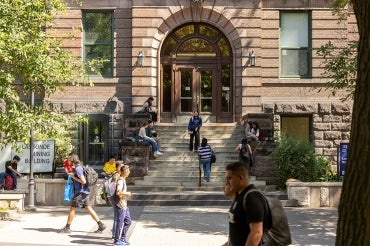 students walking in front of the Lassonde Mining Building on a warm fall day