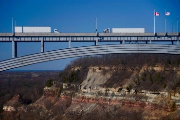 two trucks crossing in opposite directions at the queenston-lewiston bridge near Niagara Falls connecting the USA and Canada