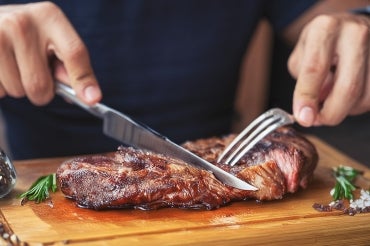 man eating a steak