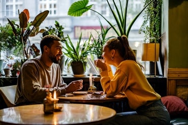 a mixed couple have a romantic date at a cafe
