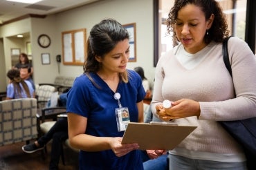 nurse with a patient in a hospital waiting room