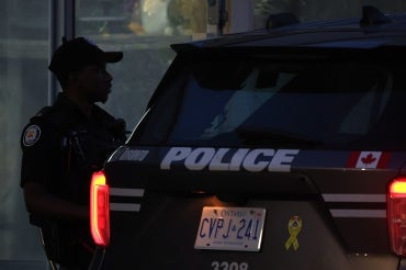 a toronto police officer and a squad car