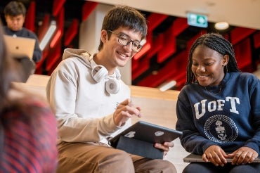 two students looking at an ipad together