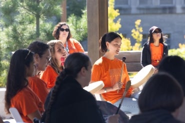 participants in a drumming circle at the Ziibiing Indigenous Garden outside of Hart House on the National Day for Truth and Reconciliation