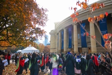 outside convocation hall with fall leaves on the trees visible