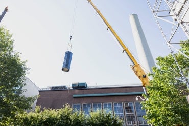 new electric boiler is being lowered into the central steam plant