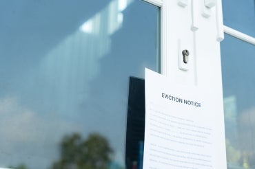 a paper sign on a door reads "eviction notice"
