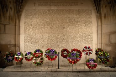 wreaths are laid by the wall of names of fallen soldiers and soldiers tower
