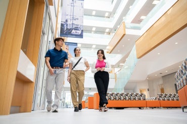 three students walk the halls at the. environmental sciences building at U of T Scarborough campus