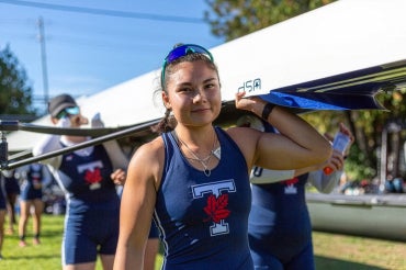 Vanessa Lin seen carrying a boat with her teammates