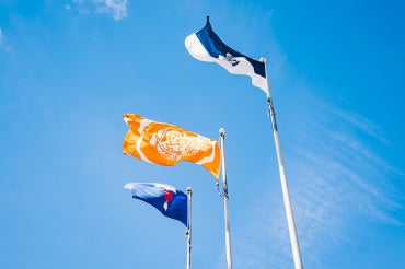Survivors flag as seen on U of T St. George campus alongside the Varsity Blues Flag and the U of T Flag
