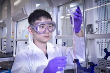 Student conducting an experiment in class