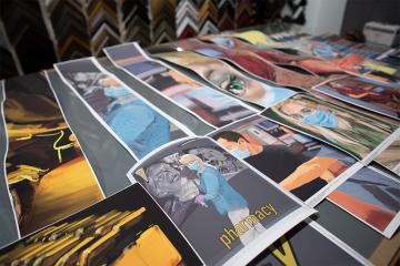 a table full of test strips of greg ellwand's paintings