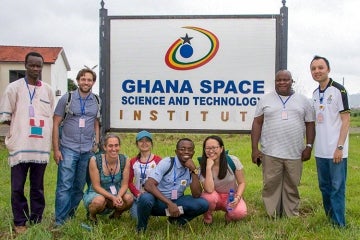 Linda Strubbe in front of a sign that says Ghana Space Science and Technology Institute