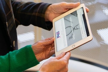 hands holding a tablet running the SSPedi tool 