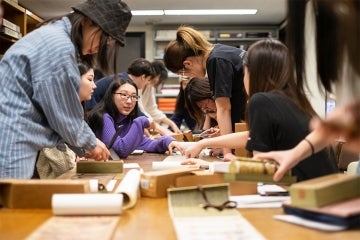 asian students look over materials in the east asian library at robarts