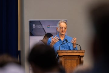 Geoffrey Hinton speaking from the stage at Toronto Tech Week