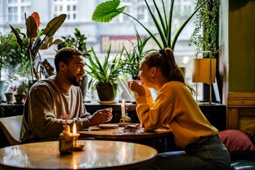 a mixed couple have a romantic date at a cafe