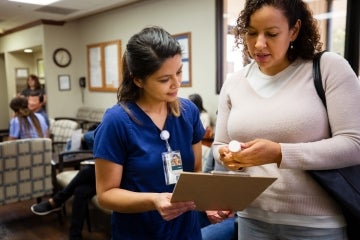 nurse with a patient in a hospital waiting room