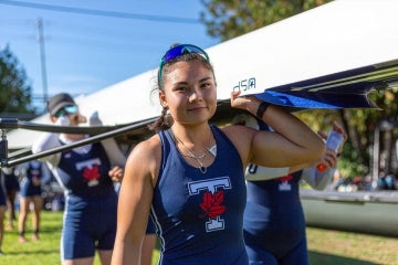 Vanessa Lin seen carrying a boat with her teammates