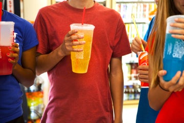teens drinking soda pop in a variety store(