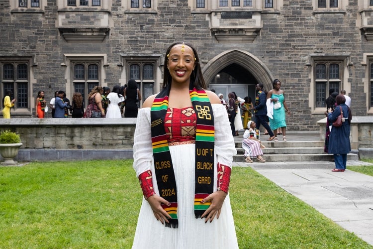 Naomi Tekle Kiros poses for a photo in the Hart House quad following the Black Grad ceremony