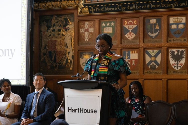 Doyin Adeyemi speaks at the podium during the ceremony